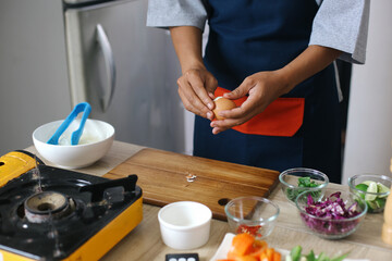 Hands Peeling A Boiled Egg For Making Chicken Soup With Noodles At Kitchen. Indonesian Traditional Food