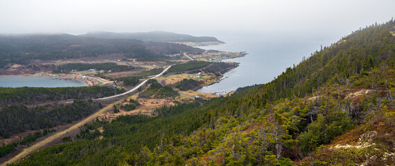 The viewing platform atop Sailor Jack's Hill provides a stunning view of the winding road descending into the Town of Conche, located on the eastern coast of the Northern Peninsula in Newfoundland. © Ralf Broskvar