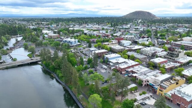 Aerial Tracking Shot of Downtown Bend Oregon with Deschutes River and Greenery