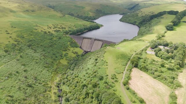 Aerial fly-in of Meldon Reservoir showcasing its serene water and surrounding landscape