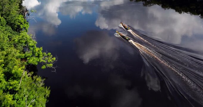 People In Longboats Cruising On Churun River In Canaima National Park, Bolivar State, Venezuela. aerial tilt-down shot