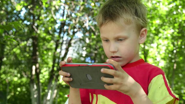 child isolated from nature due to excessive fascination with a mobile device raises concerns about the impact of technology addiction on child development.