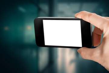 Human hands hold a mobile phone with blank screen