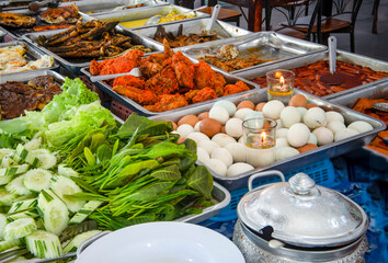 Large variety of Malaysian buffet foods,ready to eat and displayed in various steel trays,Langkawi Island,Malaysia.