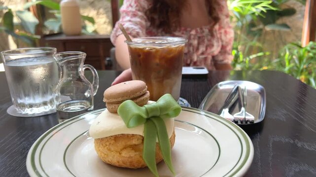 dessert with green bow and macaroon cake custard inside eclair
