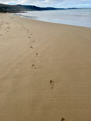 Footprints in the sand along the beach at Lorne Australia