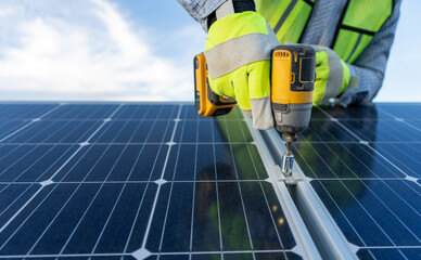 close up on hands of an unrecognizable engineer installing and giving maintenance to solar panels...