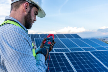engineer technician checking output voltage level of inverter, electrician measuring power on solar...