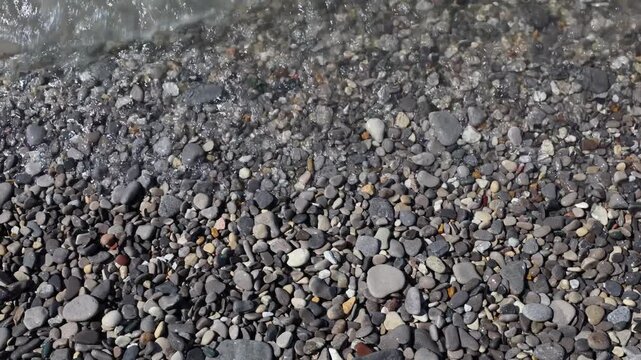 Waves wash upon the shore of a Petoskey Michigan beach