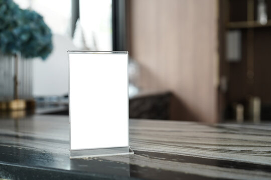 Menu&nbsp;mack up blank for text marketing promotion. Mock up Menu frame standing on wood table in restaurant space for text.