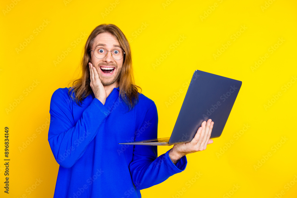 Sticker photo of cheerful glad man wear trendy blue pullover buy credit isolated on yellow color background