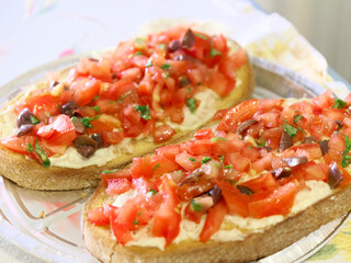 delicious bruschetta with tomatoes, olives, basil and mayonnaise