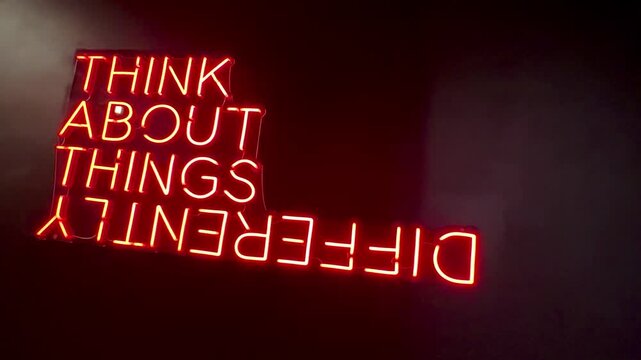 Think About Things Differently Red Neon Sign on oblique angle