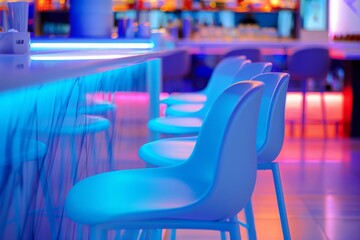 Interior of a modern bar with blue chairs.