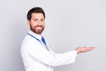 Profile portrait of experienced doctor man hold empty space wear white coat isolated on grey color background