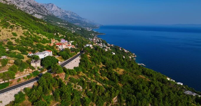 Aerial descending shot of the coastline of the Makarska riviera in sunny Croatia