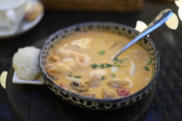 A warm bowl of soup served with a utensil, perfect for comfort food and casual dining.