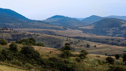 Mountain farmland landscape with haystacks