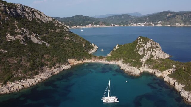 Porto Timoni Beach near Afionas Village with an anchored Catamaran, Corfu Island, Greece