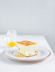 No crust cheesecake, cottage cheesecake pudding with raisin, on ceramic plate drizzled with honey. Breakfast or dessert.