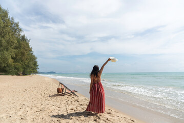 Woman Enjoying at Beach. Summer Vacation, blue sky background. Travel and lifestyle Concept