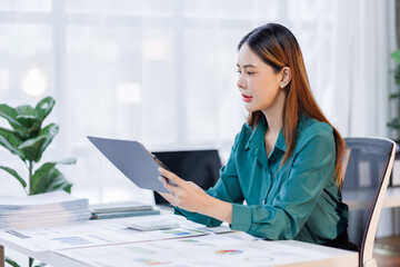 Business asian woman in the workplace analyse investment marketing analytical charts and graphs data business people business financing accounting banking concept.