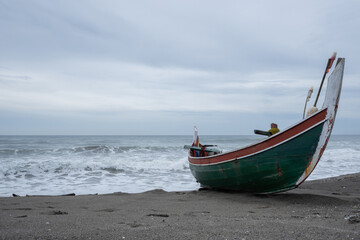Fototapeta premium A view of a traditional Indonesian fishing boat being pulled up onto the beach