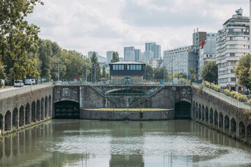 Flanders bridge lock on the river in Paris, viewed from the norh. Visible high rise buildings in the rear. Famous river locks in Paris
