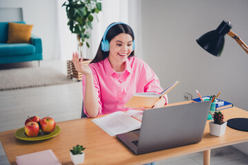 Photo of positive good mood woman dressed pink shirt headphones remote education modern device indoors house apartment room