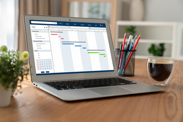 Fototapeta premium Project planning software for modish business project management on the computer screen showing timeline chart of the team project