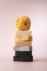 A stack of soap bars and a natural sea sponge