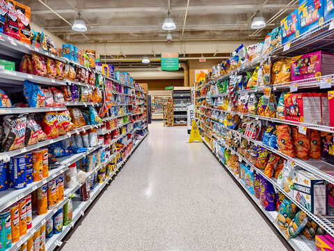 Miami Beach, Florida - Wide-angle shot of the snack aisle within a Publix supermarket in South Beach, showcasing various chips and snacks on well-stocked shelves.