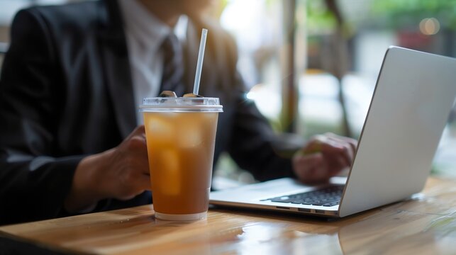 Young Businessman executive entrepreneur financial or marketing manager working on a laptop, performing online tasks in a café or restaurant with a cup of coffee technology and business, network 