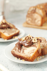 A piece of marble biscuit with chocolate cream and nuts	