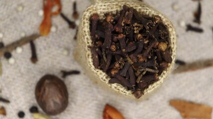 Various Indian Spices of rotation. Spice cloves on center in carpet background. Table top spin view concept.  - Powered by Adobe