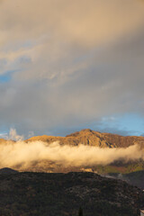 a low angle shot with the clouds in a mountain