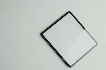 A stylish tablet featuring a black border is artistically placed at an angle on a white background, highlighting its sleek and contemporary design.