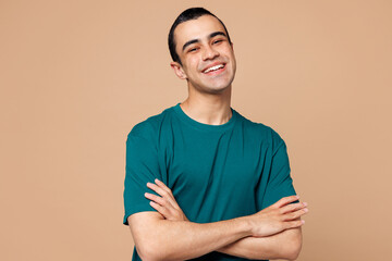Young smiling fun happy middle eastern man wear blue t-shirt casual clothes looking camera hold...