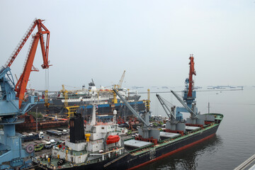 Fototapeta premium Container Ship Docked In The Port For Loading And Unloading Containers