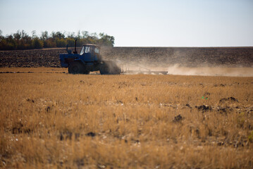 Tractor plowing fields -preparing land for sowing