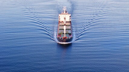 Aerial front view of Bulk cargo carrier ship for carrying dry cargo cruising across the sea