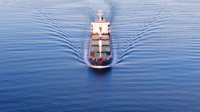 Aerial front view of Bulk cargo carrier ship for carrying dry cargo cruising across the sea