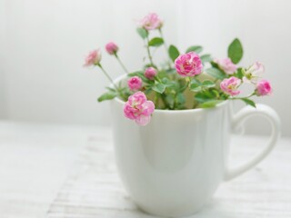 pink flowers in a cup
