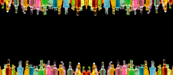 various miniature bottles of alcohol without labels with black bacground