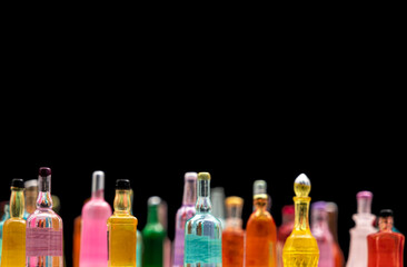 various miniature bottles of alcohol without labels with black bacground, top view