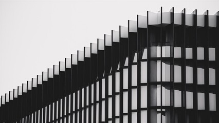 Obraz premium Modern Architecture Facade: A study in contrasts, this black and white image showcases the sharp angles and geometric beauty of a contemporary building's facade. 