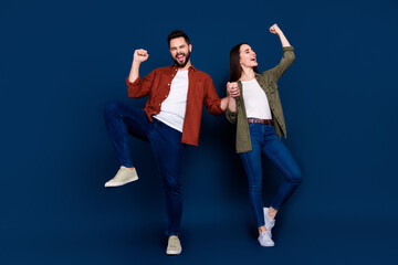 Photo of positive lovely partners wife husband wear stylish clothes celebrate sale yes isolated on dark blue color background