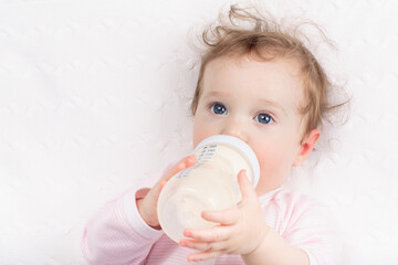 Little baby on white bed