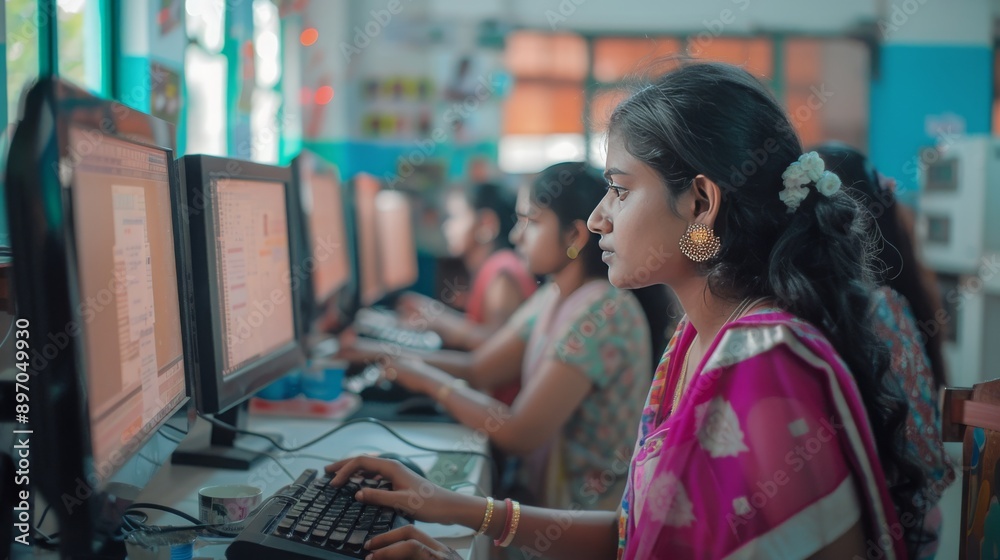 Wall mural focused indian students learning in computer lab at school using desktop computers