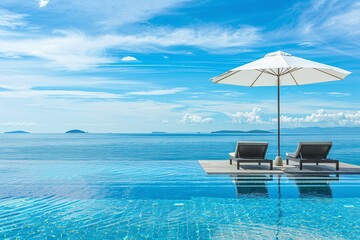 Obraz na płótnie Canvas Beautiful luxury swimming pool on sea view and umbrella
